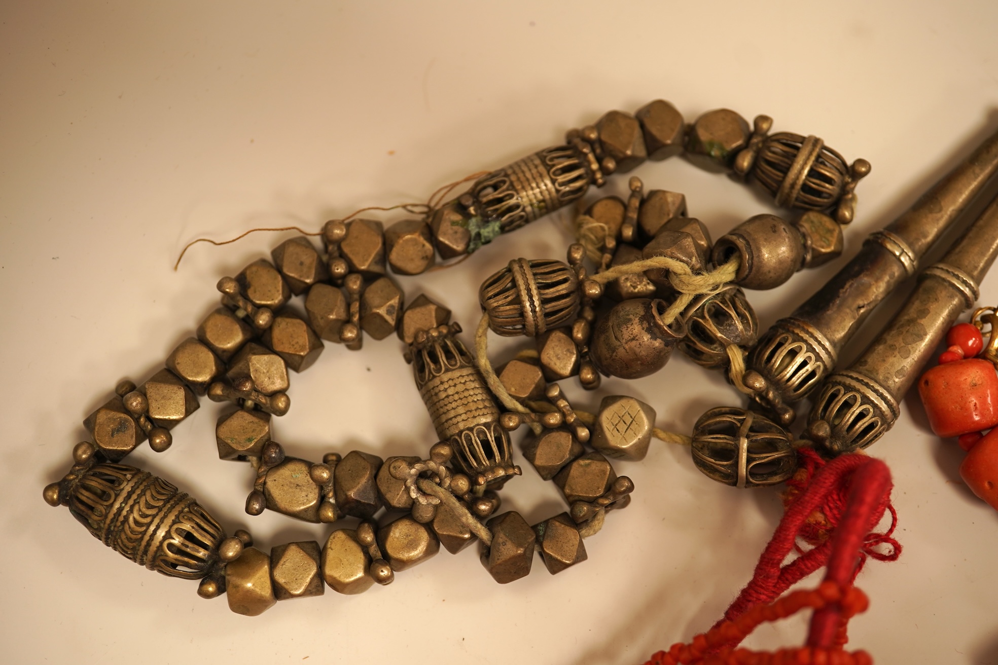 A small group of sundry jewellery including a simulated amber necklace and a multi strand coral bead necklace, etc.
